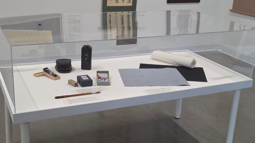 Journey into Shufa Exhibition at Clayton Community Centre Display case of Shufa tools including brush, ink, inkstone, seal and paper